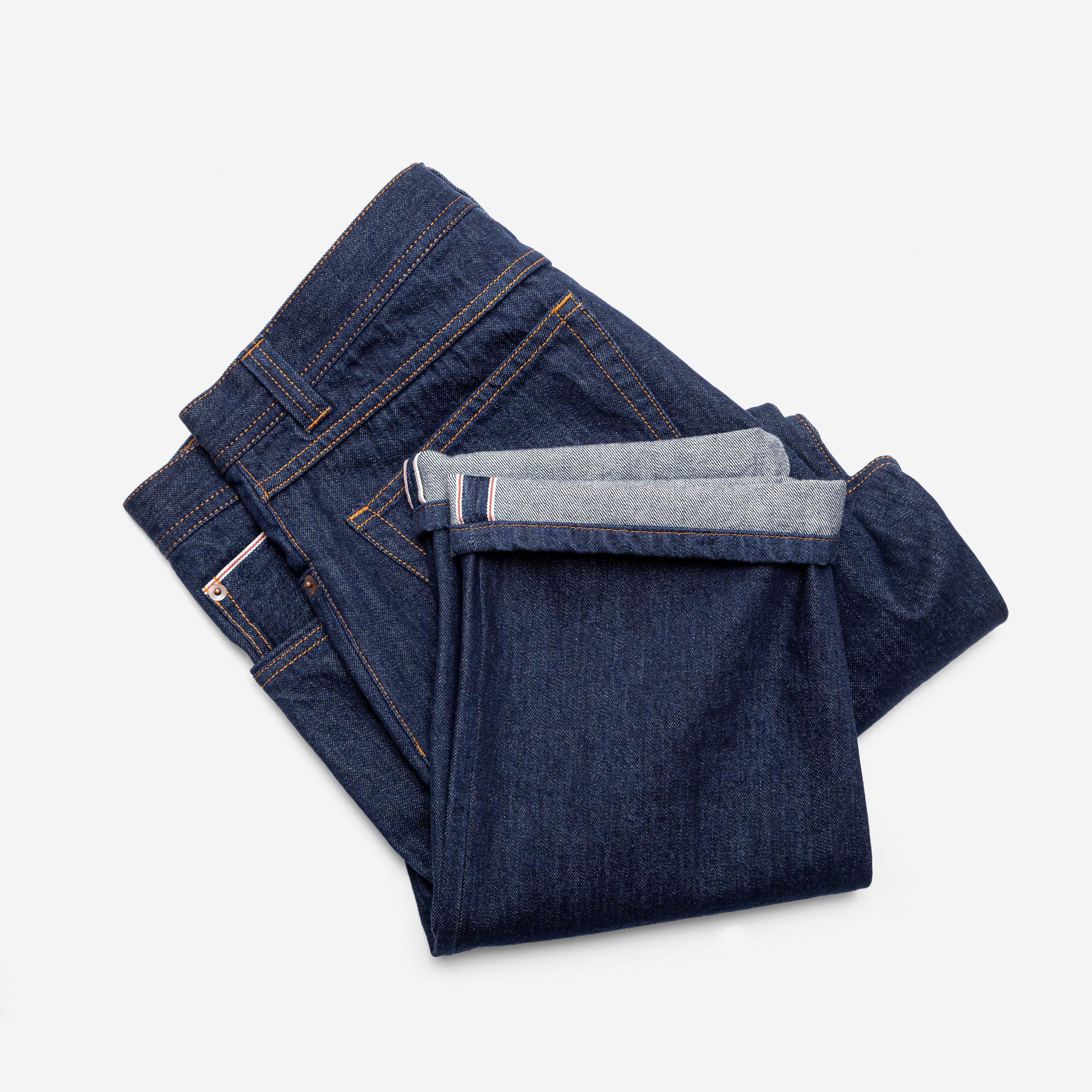 Folded indigo denim jeans by Souster & Hicks