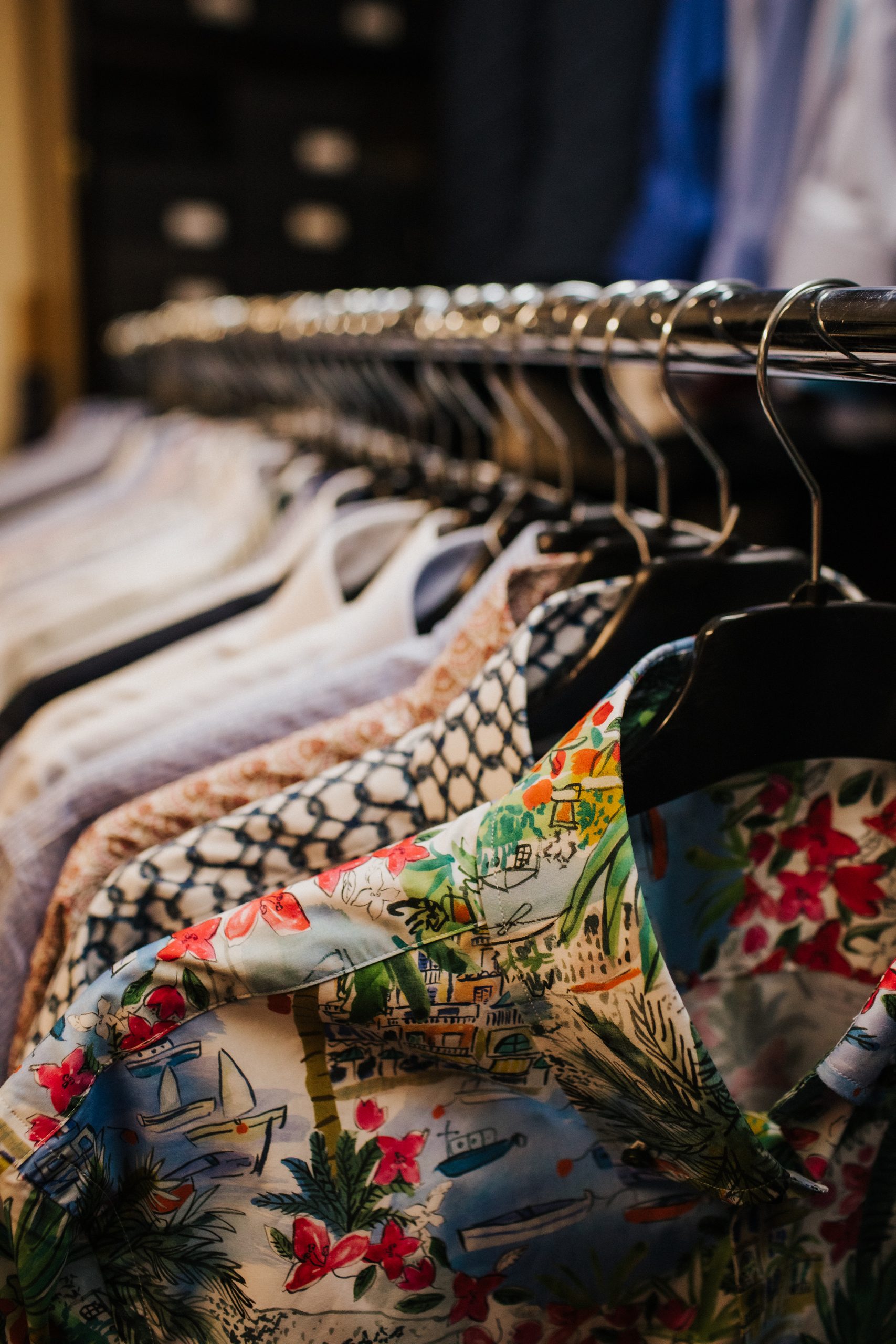 Rail of lightweight floral holiday shirts at Souster & Hicks